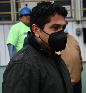 Fernando wearing a black mask and jacket at a Teamsters rally