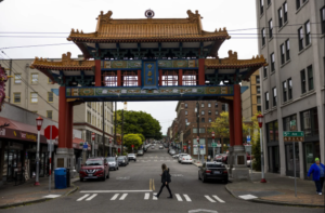 A pedestrian crosses the street on 5th Avenue South in Seattle in the Chinatown-International District in May. (Daniel Kim / The Seattle Times)